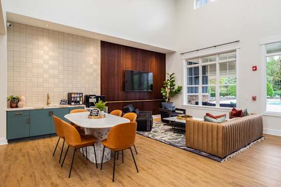 A modern living room with a dining table and chairs.