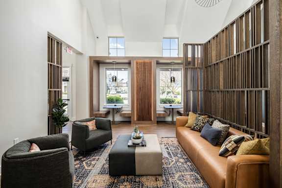A living room with a brown couch and a coffee table.