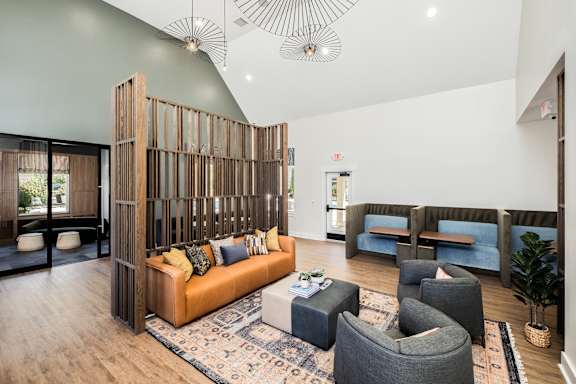 A modern living room with a wooden partition and a sofa.