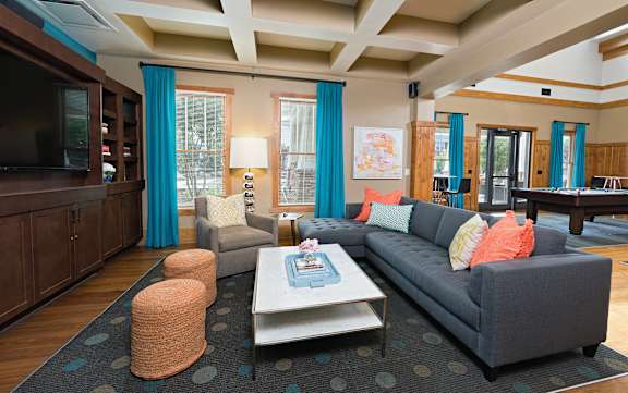 A living room with a grey couch and a coffee table.