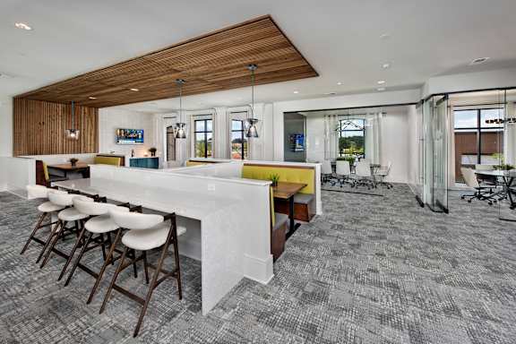 A conference room with a long table and chairs.
