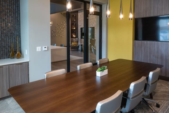 a dining room with a wooden table and chairs