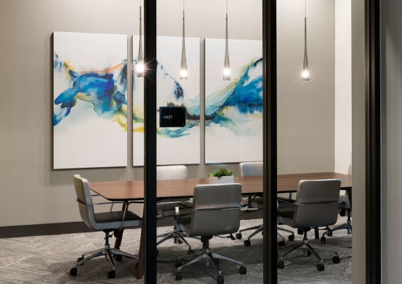 a conference room with a wooden table and chairs