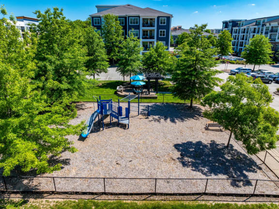 an aerial view of a playground in a park with trees