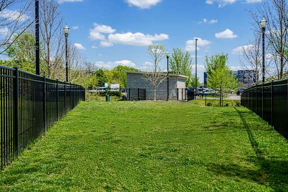 A small building sits in the middle of a grassy area.