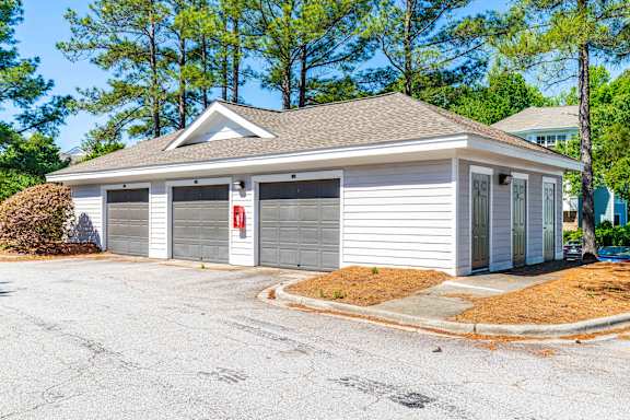 A two-car garage with a red fire extinguisher on the side.