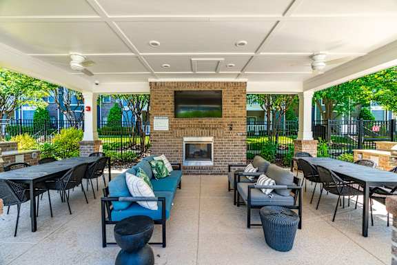 A patio with a fireplace and seating area.