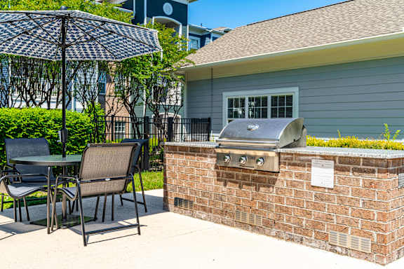 A patio with a table, chairs, and an umbrella is shown.