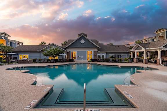 A large swimming pool surrounded by a residential area.