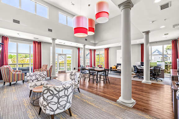 A large room with a long table and chairs.