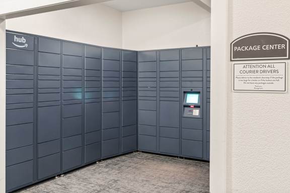 A sign in a room that says "Package Center" and "Attention All Courier Drivers".