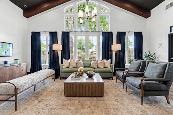 A living room with a large window and a couch.