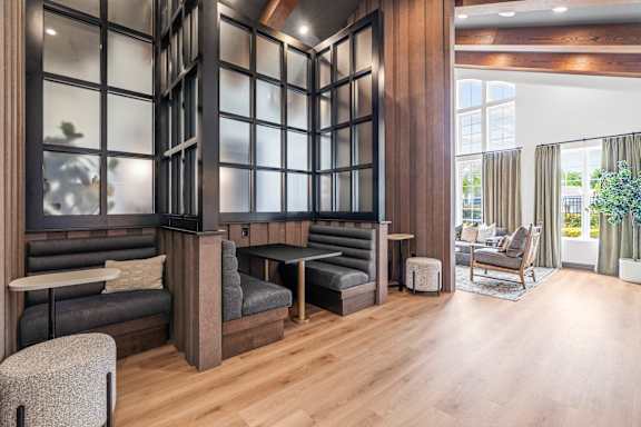 A modern living room with a grey sofa and a wooden floor.