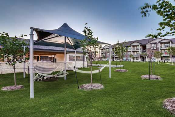 A modern building with a hammock in front of it.