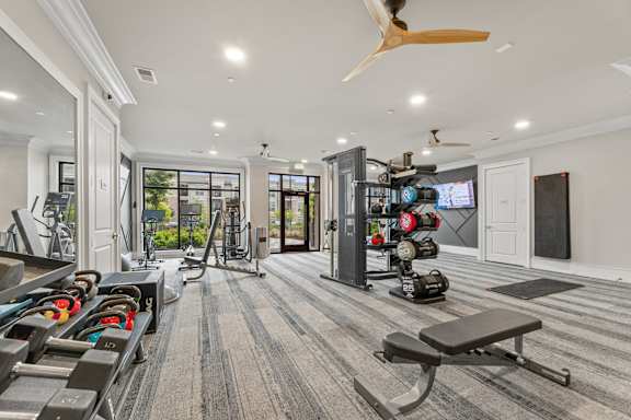 A spacious home gym with a variety of equipment.