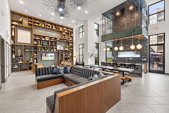 A modern interior of a building with a large open space and a wooden reception desk.