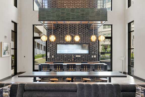 A modern living room with a black couch and a television.
