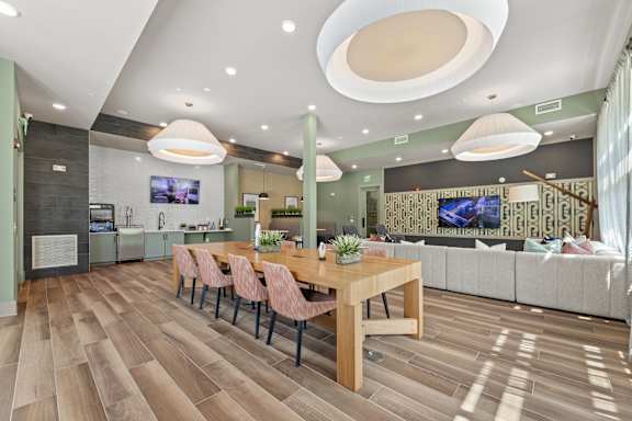 A modern dining room with a wooden table and chairs.