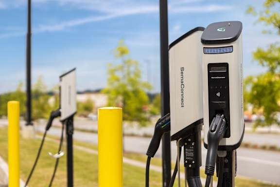 A SemaConnect electric vehicle charging station is shown with a plugged in car.