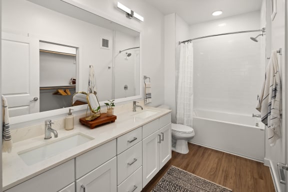 a bathroom with white cabinets and a shower and a toilet