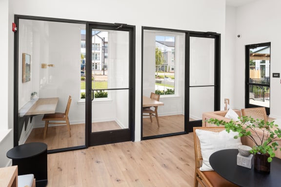 a living room with sliding glass doors and a table and chairs
