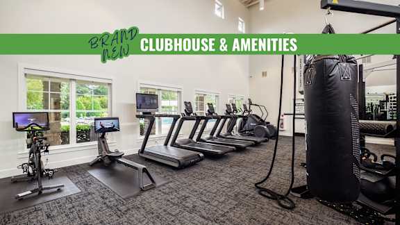 A gym with a green banner that says "Brand New Clubhouse & Amenities".
