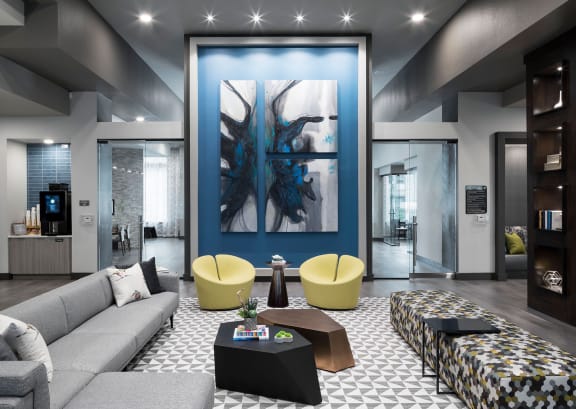 a living room with a blue wall and a couch and tables