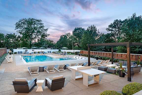 A poolside area with a table and chairs.