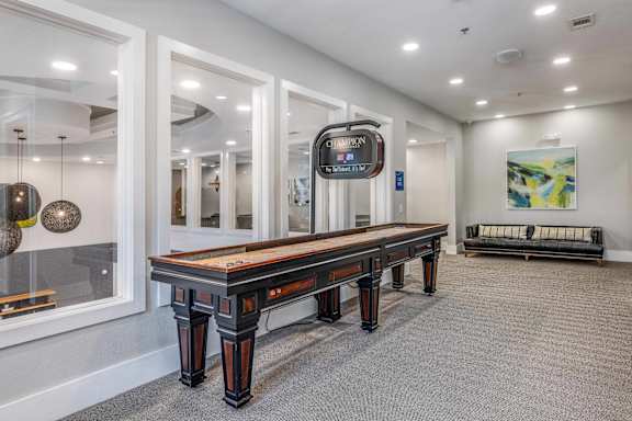 A long wooden table is in the middle of a room with a bench to the side.