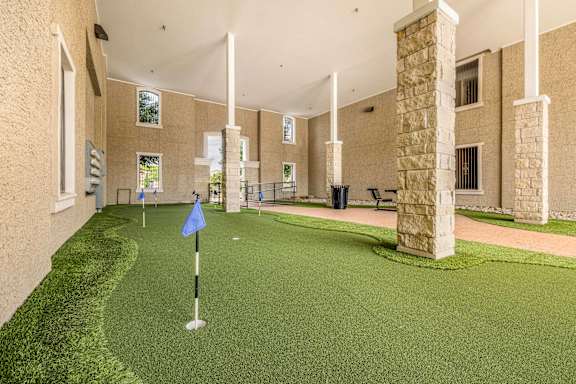A miniature golf course is set up inside a building.