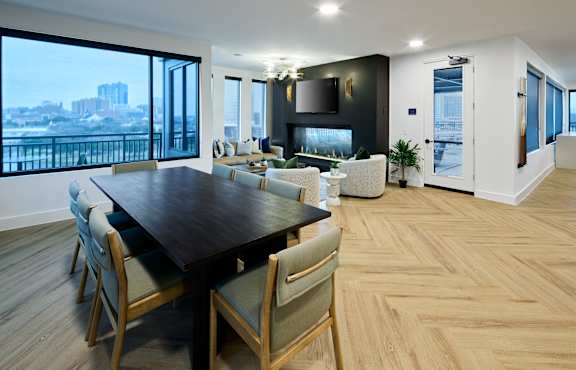 A modern dining room with a large table and chairs.