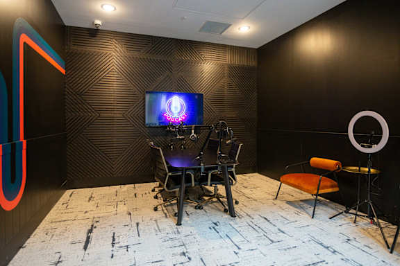 A room with a television and a chair.
