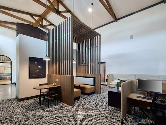 A modern office space with a wooden partition and a black and white checkered floor.