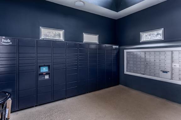 A room with a row of lockers and a calendar on the wall.