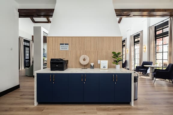 A kitchen area with a wooden counter and blue cabinets.