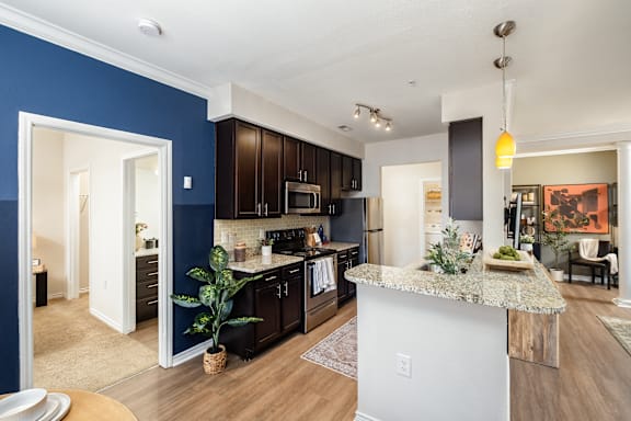 A kitchen with a blue wall and a white island.
