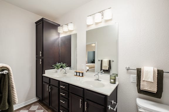 A bathroom with a white sink and a mirror above it.