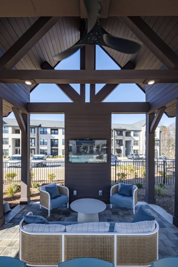 a patio with a table and chairs and a tv