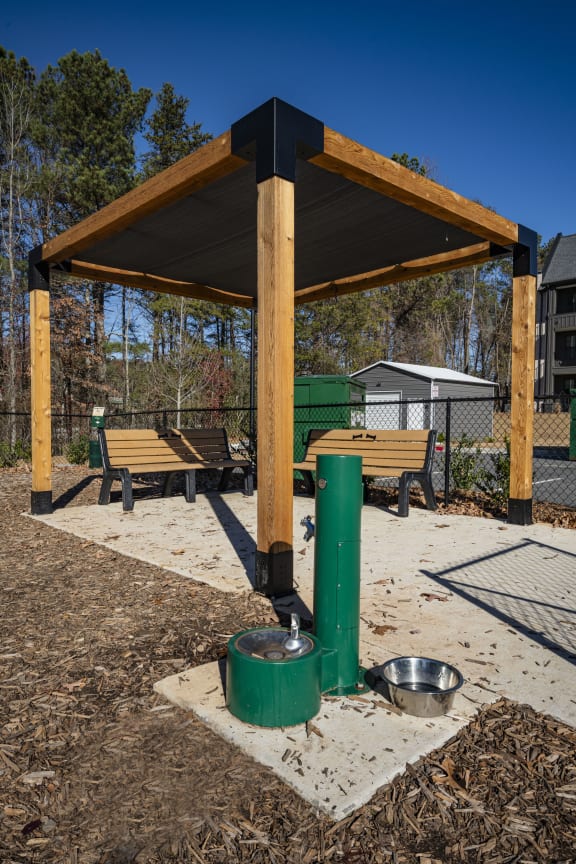 a water fountain in a park with benches