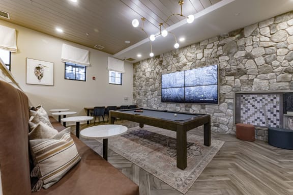 a conference room with a stone wall and a table in the middle