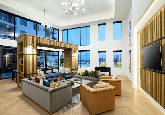 A modern living room with a large sectional sofa and a wooden coffee table.