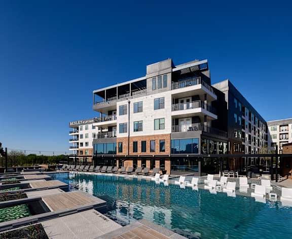 A modern building with a pool in front.