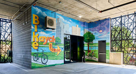A mural on a wall with a bicycle and the words "Bike Hayak Storage".