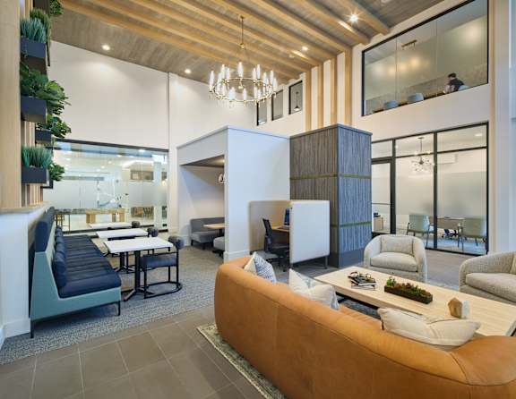 A modern living room with a brown sofa and a wooden ceiling.