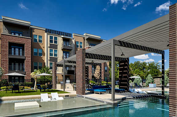 A modern building with a pool in front.