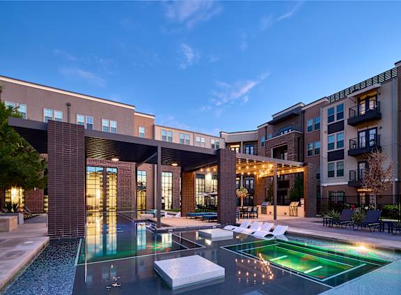 A modern building with a pool in front.