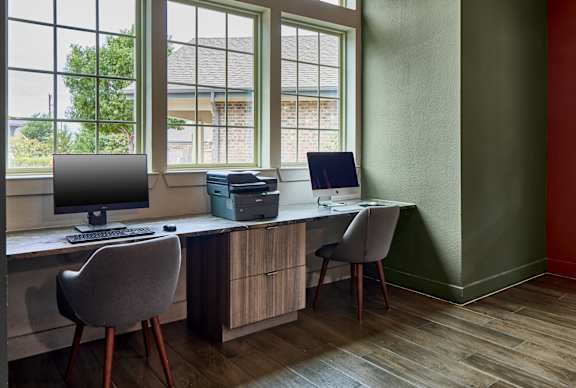 A room with a desk, chair, and computer.