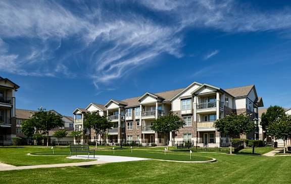 A large apartment complex with a playground in the foreground.