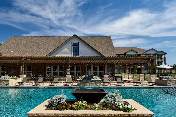 A large house with a pool in front.