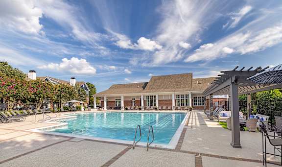A large swimming pool with a building in the background.